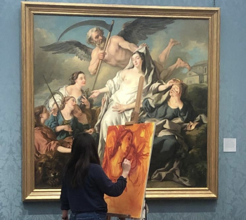 A woman painting a copy of an old master painting in a gallery.